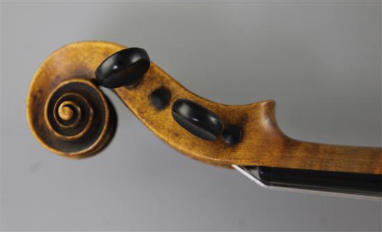 A violin bearing label for Maggini and date 1616, 14.5in., length overall 23.5in.